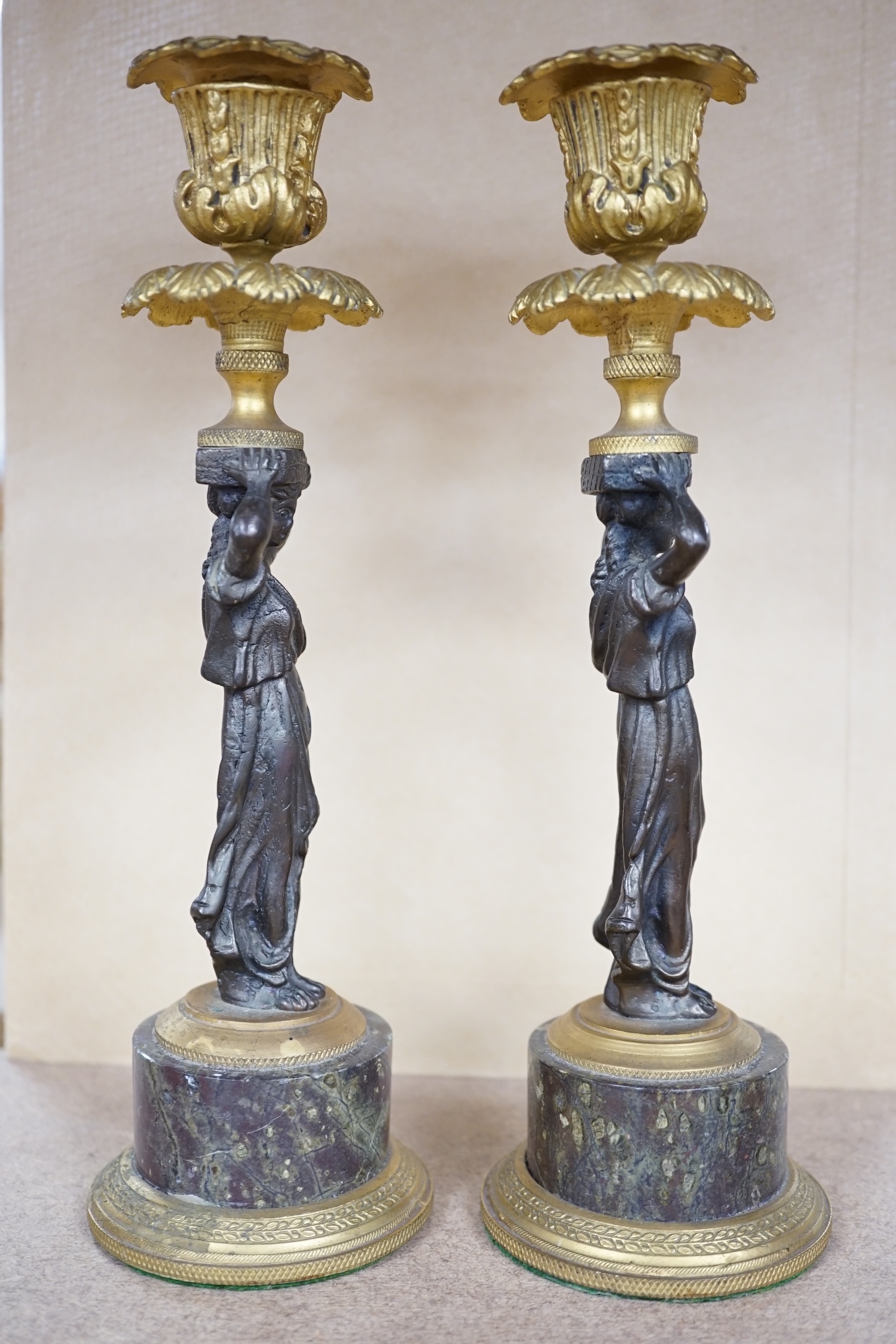 A pair of Regency style bronze and ormolu figural candlesticks on serpentine plinths, 22.5cm. Condition - fair to good